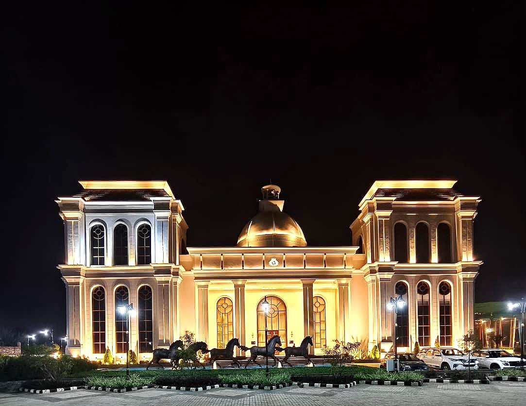 Exteriors — resort building at night with palm trees